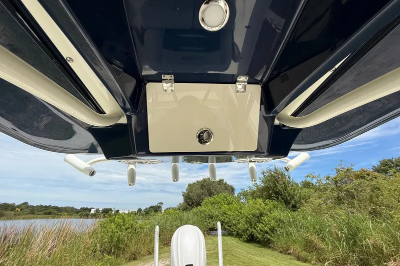Slide: The Image of 2026 Pathfinder 2700 Open boat underside view with rod holders and storage compartment. - 39