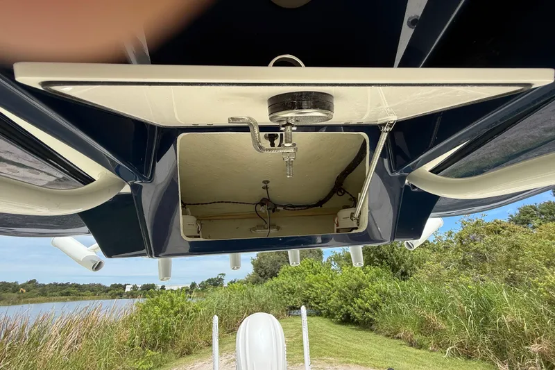 Slide: The Image of 2026 Pathfinder 2700 Open boat with open hatch, showcasing interior components and scenic background. - 40