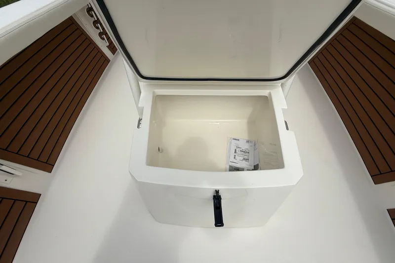 Slide: The Image of Open storage compartment on 2026 Pathfinder 2700 Open boat, featuring teak-style flooring. - 48