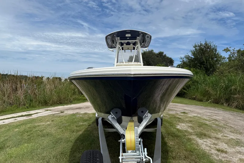 Slide: The Image of 2026 Pathfinder 2700 Open boat on trailer, surrounded by greenery and blue sky. - 9