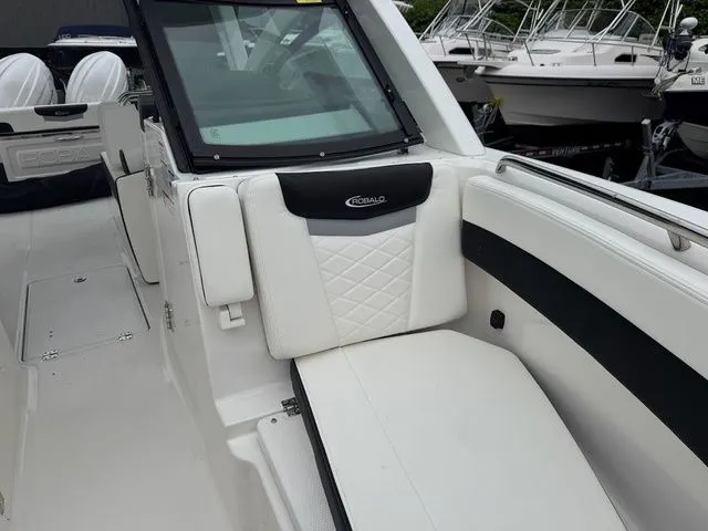 Slide: The Image of 2025 Robalo R257 boat interior with white seating and black accents. - 11