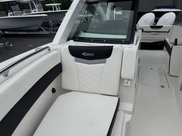 Slide: The Image of 2025 Robalo R257 boat interior with white and black seating. - 12
