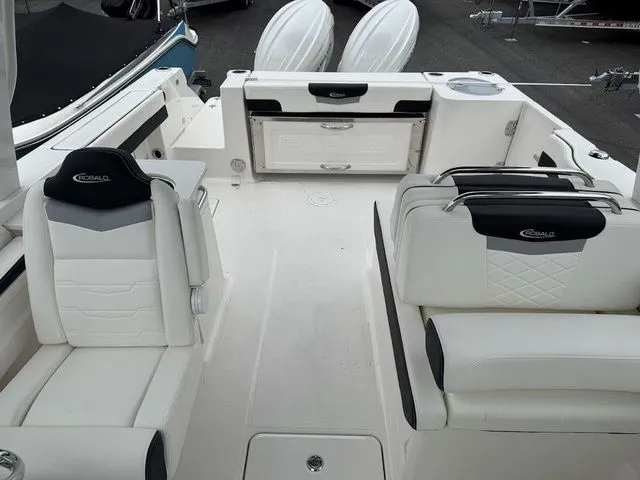 Slide: The Image of 2025 Robalo R257 boat interior with white seating and storage compartments. - 13