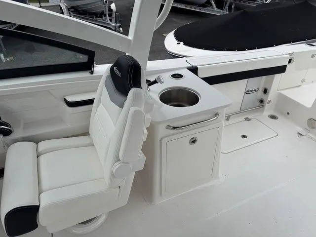 Slide: The Image of 2025 Robalo R257 boat interior with white seating and sink area. - 14
