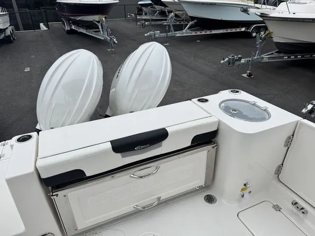 Slide: The Image of 2025 Robalo R257 boat with dual engines and spacious deck, parked among other boats. - 4