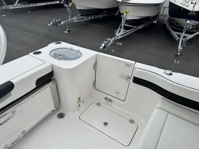 Slide: The Image of 2025 Robalo R257 boat interior with storage compartments and seating, displayed in a showroom. - 5