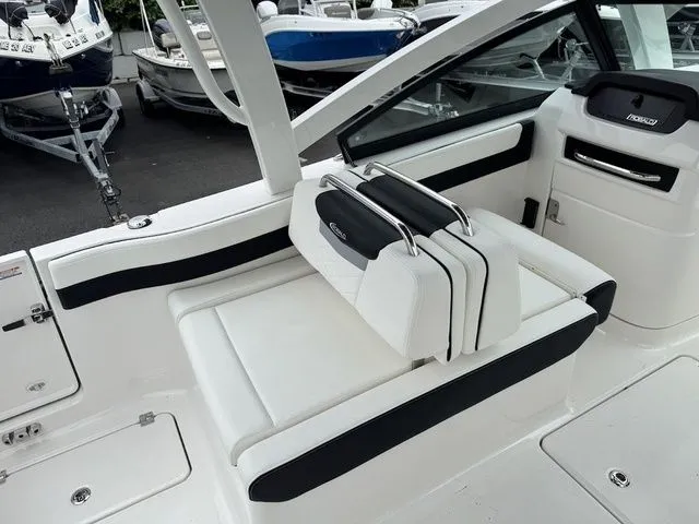 Slide: The Image of 2025 Robalo R257 boat interior with white seating and black accents. - 6