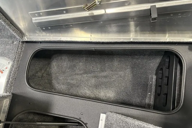 Slide: The Image of 2026 Tracker Pro Team 175 Crappie Edition boat storage compartment, open and empty. - 11