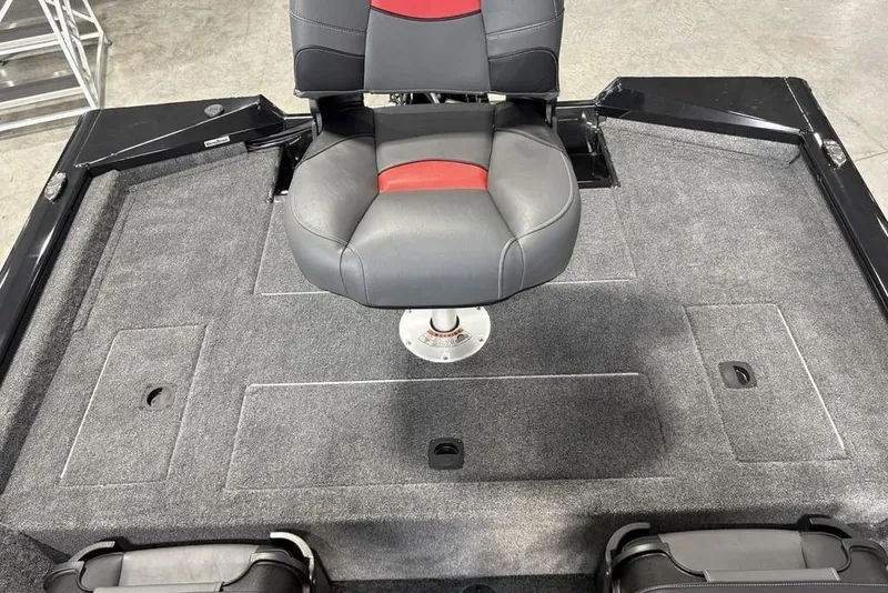 Slide: The Image of 2026 Tracker Pro Team 175 Crappie Edition boat seat on carpeted deck. - 19