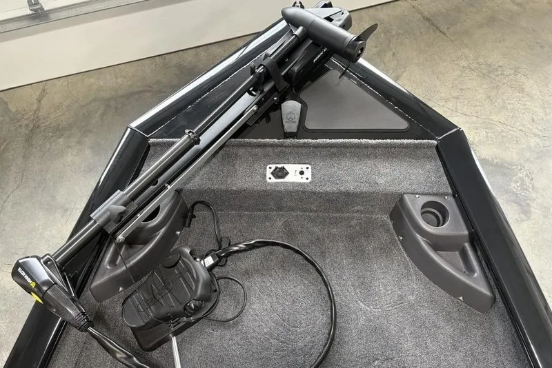 Slide: The Image of 2026 Tracker Pro Team 175 Crappie Edition boat interior with trolling motor and carpeted deck. - 2