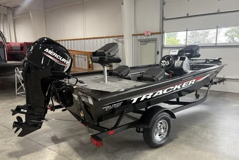 Slide: The Image of 2026 Tracker Pro Team 175 Crappie Edition boat with Mercury engine in showroom. - 3