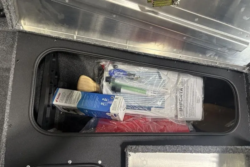 Slide: The Image of Storage compartment in 2026 Tracker Pro Team 175 Crappie Edition boat, containing various items. - 5
