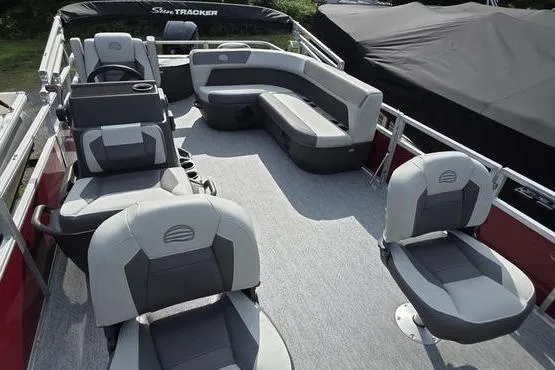Slide: The Image of 2026 Sun Tracker BB 18 DLX pontoon boat interior with gray seating and spacious layout. - 10