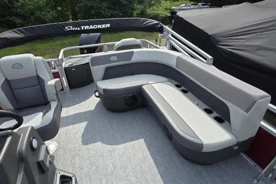 Slide: The Image of 2026 Sun Tracker BB 18 DLX pontoon boat interior with gray seating and carpeted floor. - 4