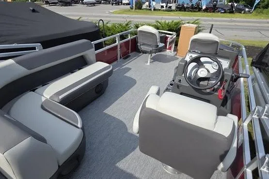 Slide: The Image of 2026 Sun Tracker BB 18 DLX pontoon boat interior with seating and steering console. - 5