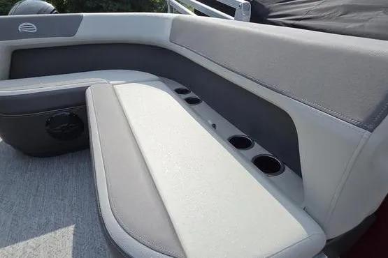Slide: The Image of 2026 Sun Tracker BB 18 DLX boat interior with cushioned seating and cup holders. - 8