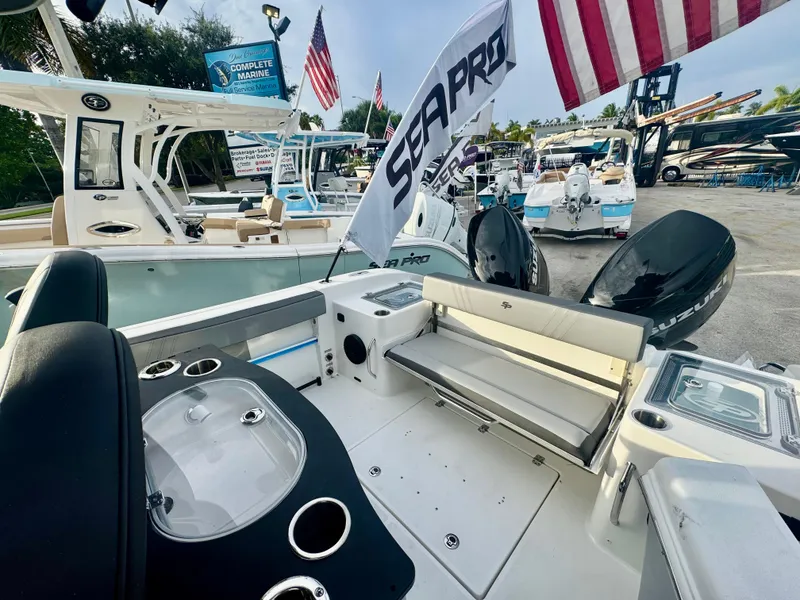 Slide: The Image of 2026 Sea Pro 292 DLX boat interior with dual Suzuki engines and American flag. - 12