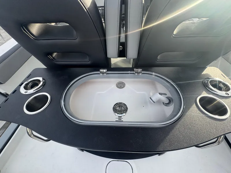 Slide: The Image of 2026 Sea Pro 292 DLX boat interior with sink and cup holders. - 22
