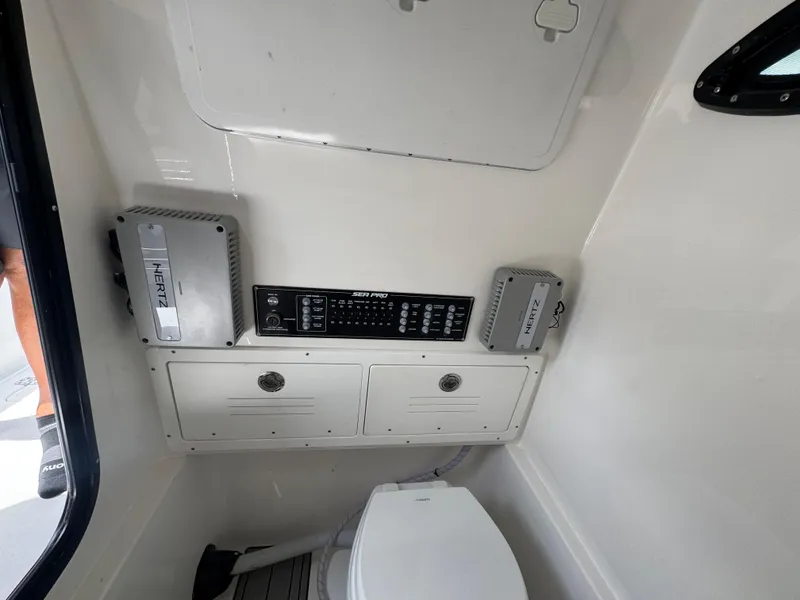 Slide: The Image of Interior of 2026 Sea Pro 292 DLX boat with control panel and storage. - 34