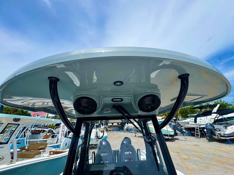 Slide: The Image of 2026 Sea Pro 292 DLX boat with sleek T-top and modern design in a marina setting. - 38