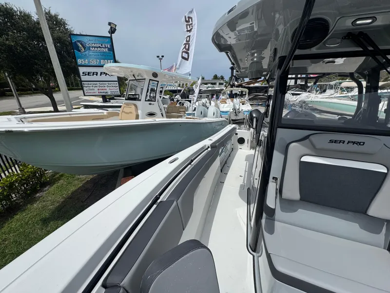 Slide: The Image of 2026 Sea Pro 292 DLX boats displayed at a marina, showcasing sleek design and features. - 40