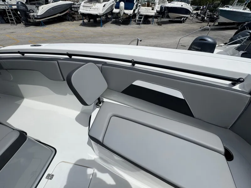 Slide: The Image of 2026 Sea Pro 292 DLX boat interior with gray seating, docked among other boats. - 41