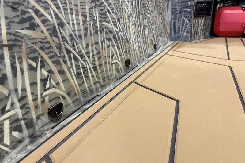 Slide: The Image of 2026 Tracker Grizzly 1650 T Prairie Wings Edition interior with camo design and tan flooring. - 11