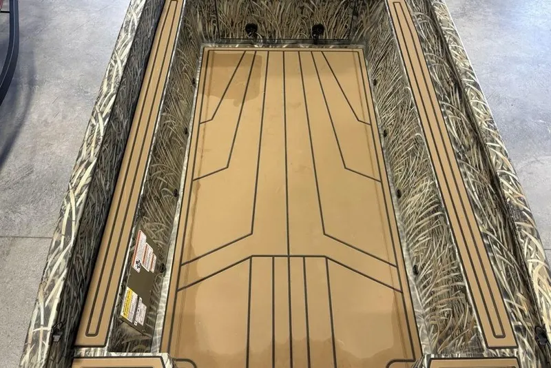 Slide: The Image of 2026 Tracker Grizzly 1650 T Prairie Wings Edition boat interior with camouflage design. - 12