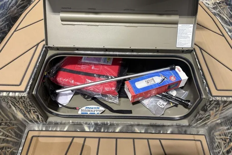 Slide: The Image of Storage compartment of 2026 Tracker Grizzly 1650 T Prairie Wings Edition with safety gear. - 9