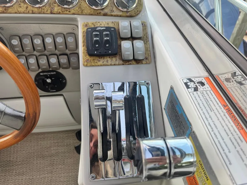 Slide: The Image of Control panel of a 2008 Formula 34 PC boat with throttle levers and switches. - 12