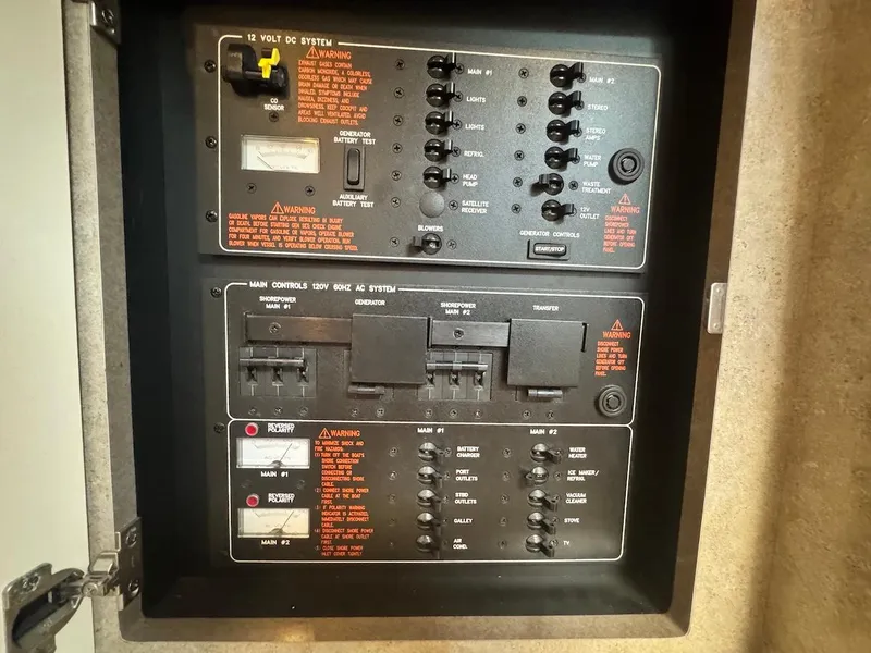 Slide: The Image of Electrical control panel of a 2008 Formula 34 PC boat, featuring switches and warnings. - 15