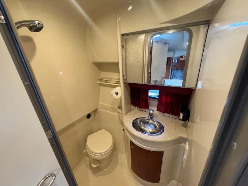 Slide: The Image of 2008 Formula 34 PC yacht bathroom with sink, toilet, and mirror. - 28
