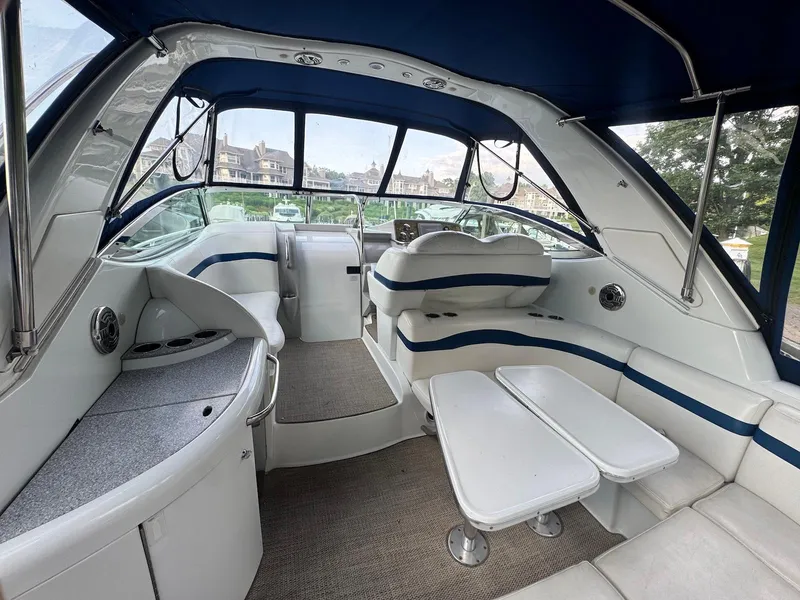 Slide: The Image of 2008 Formula 34 PC boat interior with seating, table, and helm, featuring blue and white design. - 4