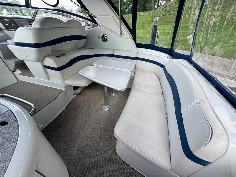 Slide: The Image of 2008 Formula 34 PC boat interior with white seating and table, featuring blue accents. - 7