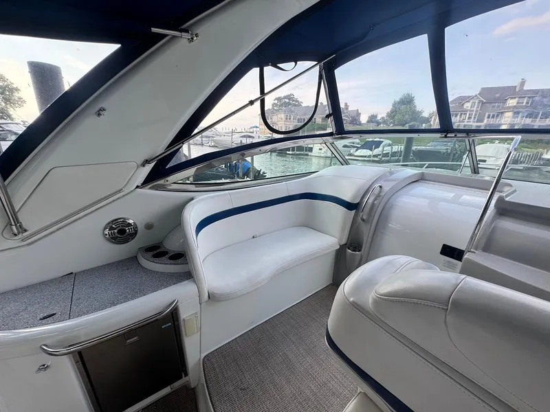 Slide: The Image of 2008 Formula 34 PC boat interior with white seating and waterfront view. - 8