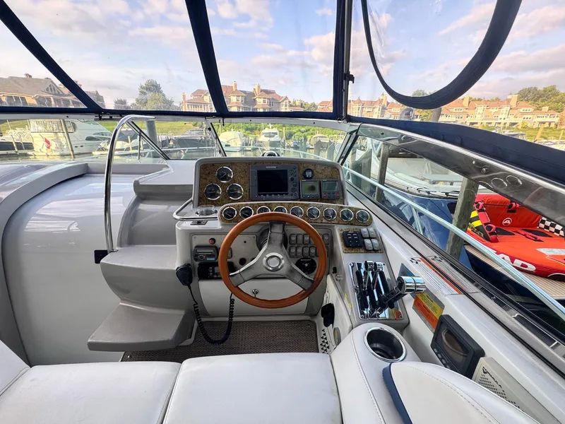 Slide: The Image of 2008 Formula 34 PC yacht cockpit with steering wheel and control panel, docked at marina. - 9