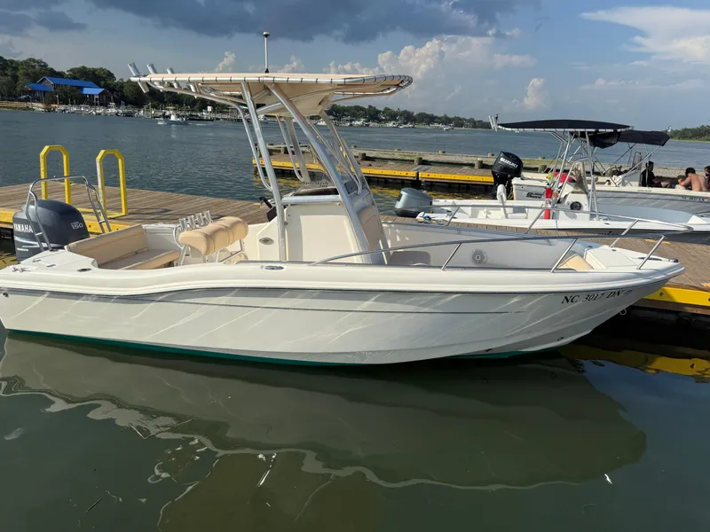 Slide: The Image of 2009 Scout 205 Sportfish boat docked on a sunny day with Yamaha outboard motor. - 10