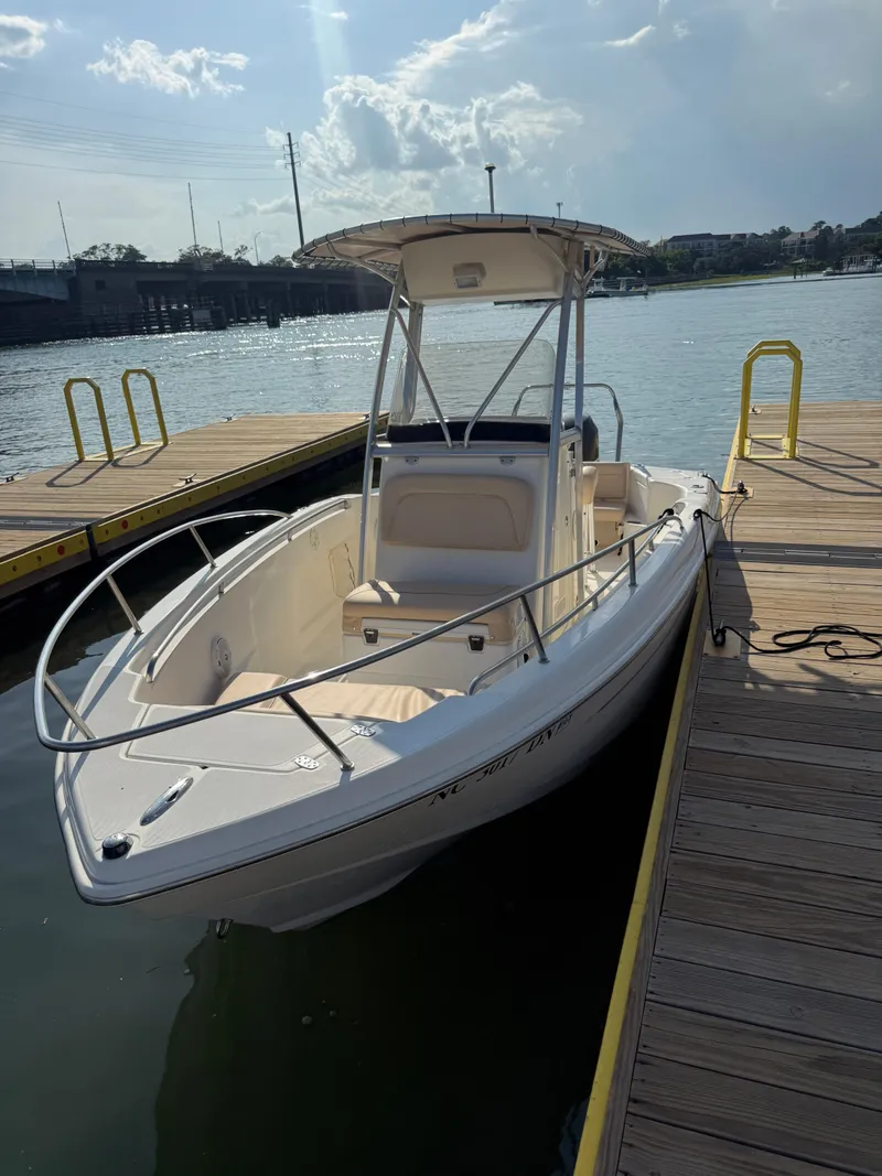 Slide: The Image of 2009 Scout 205 Sportfish boat docked on a sunny day. - 11