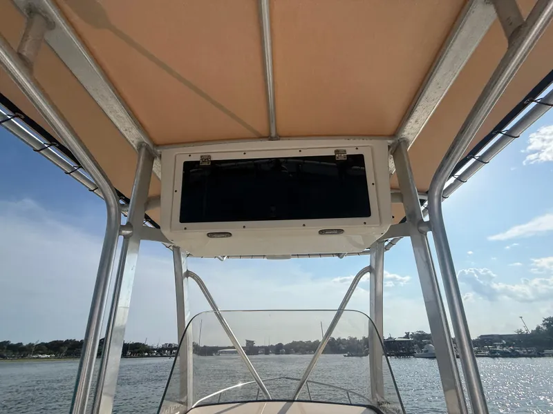 Slide: The Image of 2009 Scout 205 Sportfish boat with T-top and console, on a sunny day. - 14