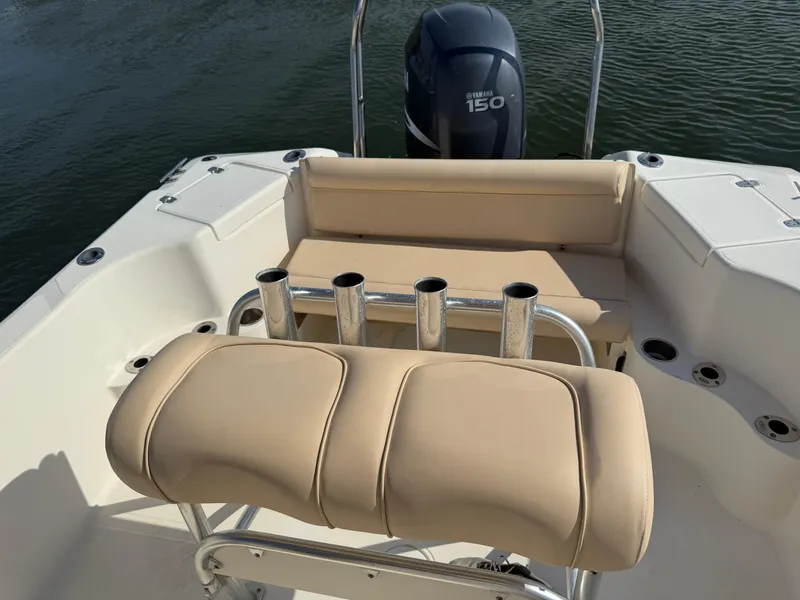 Slide: The Image of 2009 Scout 205 Sportfish boat with Yamaha 150 engine, featuring beige seating and rod holders. - 15