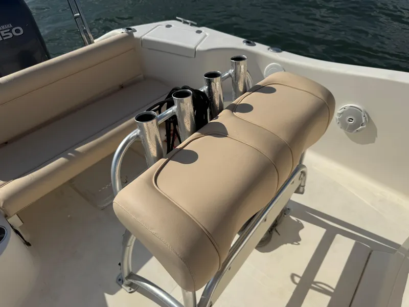 Slide: The Image of 2009 Scout 205 Sportfish boat interior with beige seating and rod holders. - 20