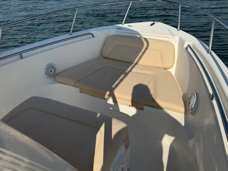 Slide: The Image of 2009 Scout 205 Sportfish boat interior with beige seating and ocean view. - 25