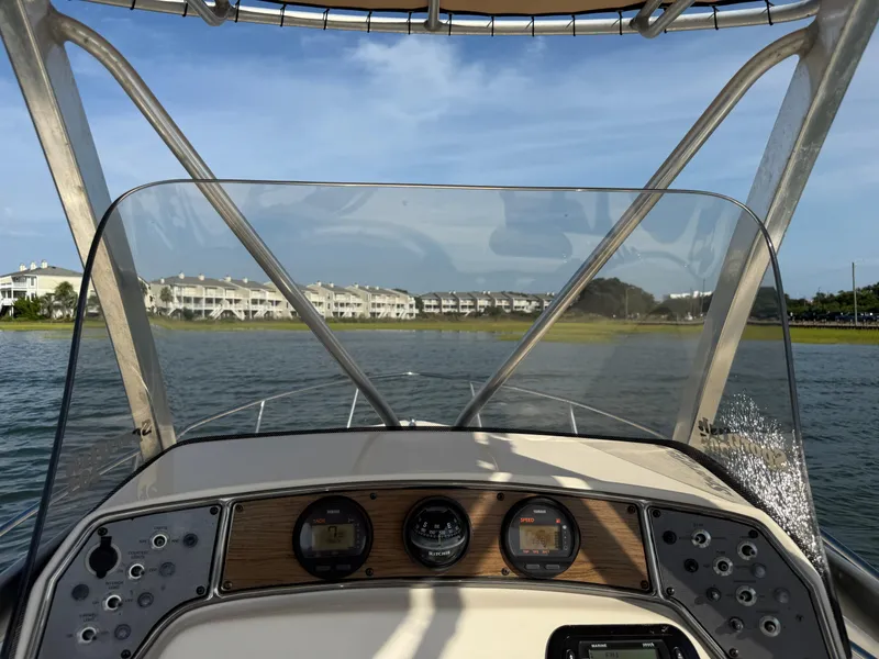 Slide: The Image of 2009 Scout 205 Sportfish boat dashboard with waterfront view. - 27