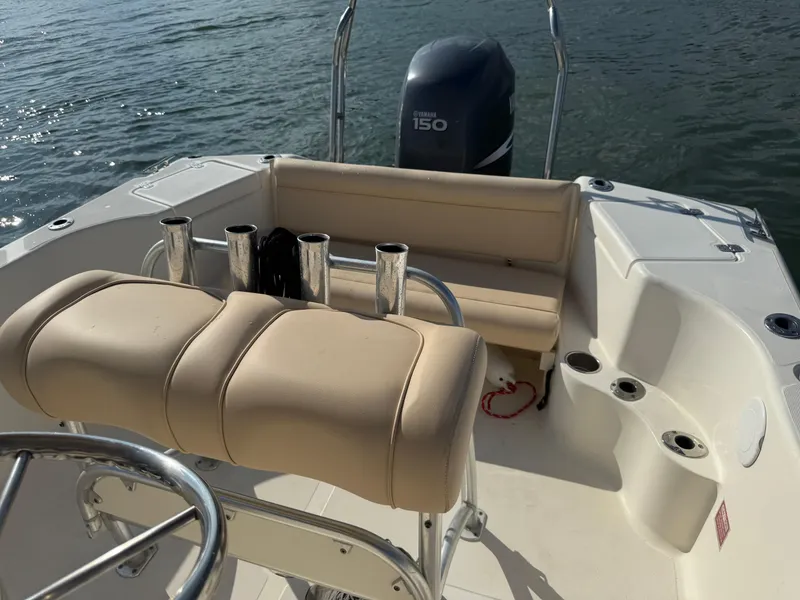 Slide: The Image of 2009 Scout 205 Sportfish boat interior with Yamaha 150 engine, beige seating, and rod holders. - 28