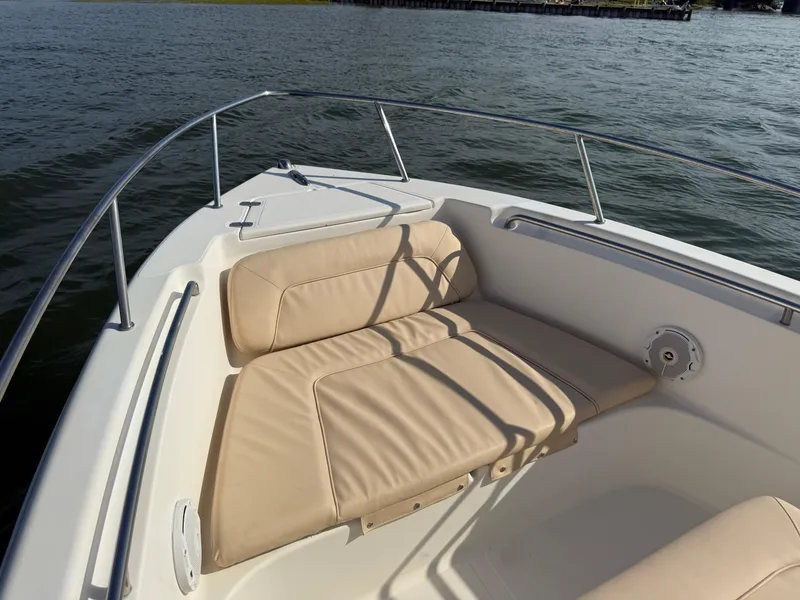 Slide: The Image of 2009 Scout 205 Sportfish boat with beige seating on calm water. - 31