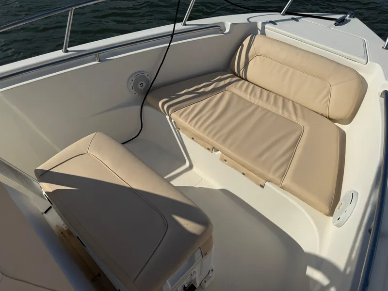 Slide: The Image of 2009 Scout 205 Sportfish boat interior with beige cushioned seating. - 36