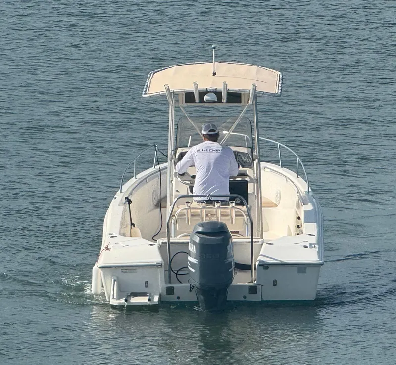 Slide: The Image of 2009 Scout 205 Sportfish boat on water, rear view with driver. - 5