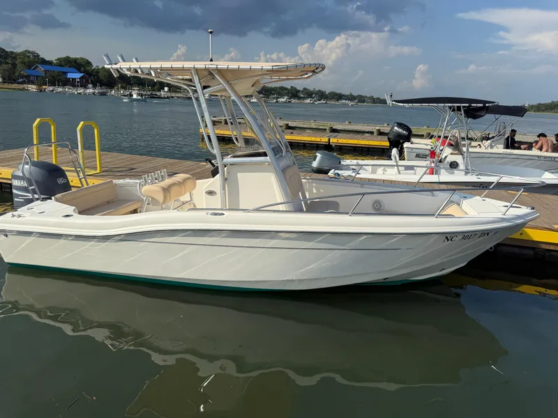 Slide: The Image of 2009 Scout 205 Sportfish boat docked on a sunny day, featuring a Yamaha outboard motor. - 7