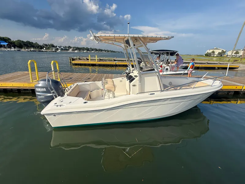 Slide: The Image of 2009 Scout 205 Sportfish boat docked with Yamaha engine, under clear sky. - 8