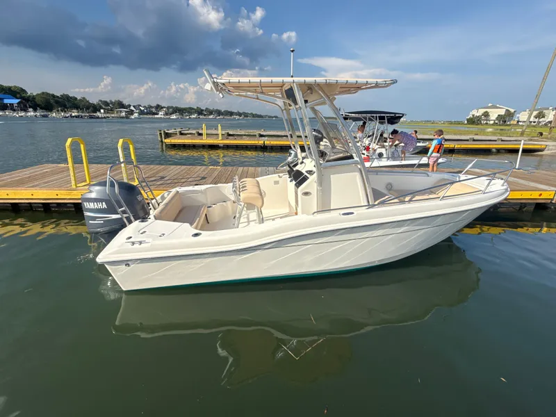 Slide: The Image of 2009 Scout 205 Sportfish boat docked with Yamaha engine, under clear skies. - 9
